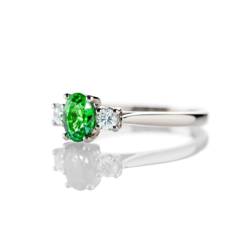 Tsavorite is a rare form of Garnet which is green.  This ring is made in Platinum and has a Diamond either side of the oval Tsavorite and as January's birthstone is a perfect gift.